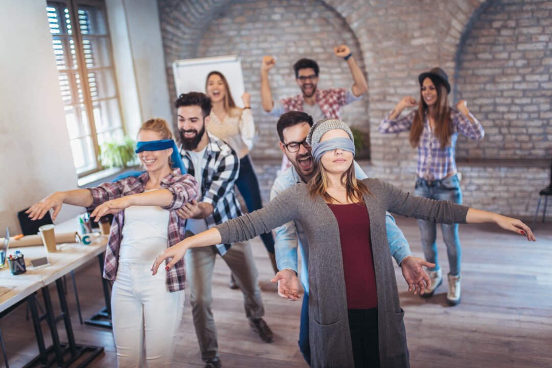 Trust exercises can help us work as a team, but learning to trust those outside our team takes something greater. (adriaticfoto/Shutterstock)