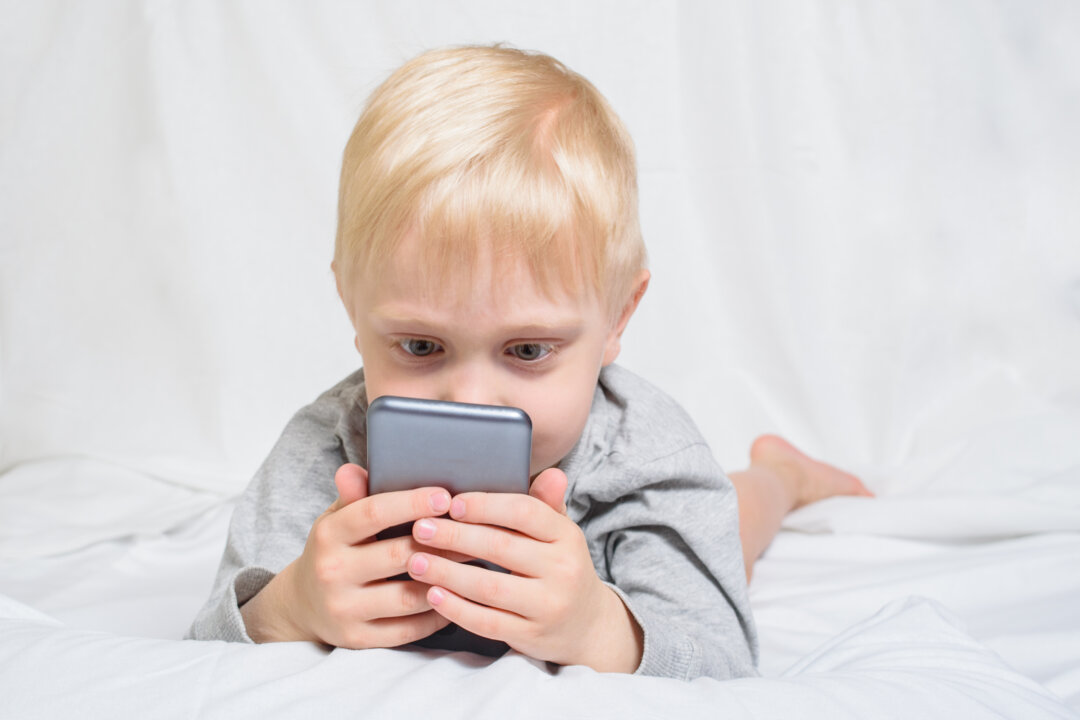 A game or video can provide parents a much needed respite, but too much screen time can harm their child's development. (somemeans/Shutterstock)