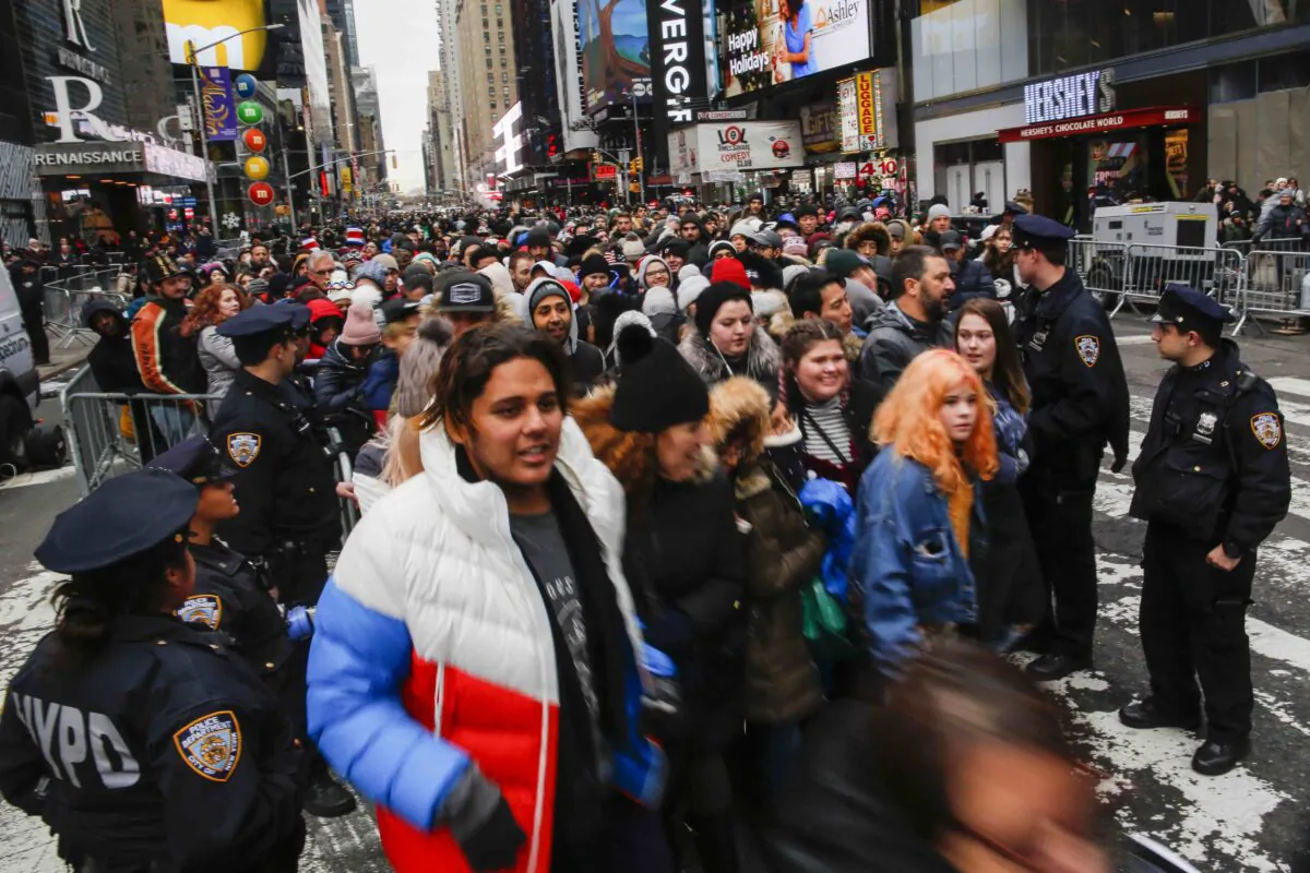NYPD officers try to control the arrival of people to celebrate New Years eve in Times Square in New York City on Dec. 31, 2019. Because of the mild weather, a larger than usual crowd of people visiting from all over the world is expected to watch the ball drop. (Eduardo Munoz Alvarez/Getty Images)