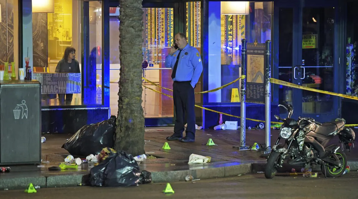 A woman looks out from inside a McDonald's fast food restaurant as New Orleans police investigate the scene of a shooting on the edge of the city's famed French Quarter on Dec. 1, 2019. (Max Becherer/The Times-Picayune/The New Orleans Advocate via AP)