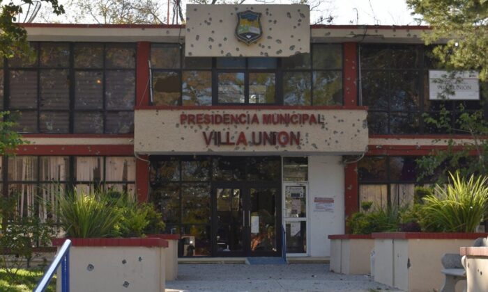 The City Hall of Villa Union is riddled with bullet holes after a gun battle between Mexican security forces and suspected cartel gunmen, Saturday, Nov. 30, 2019. (AP Photo/Gerardo Sanchez)    