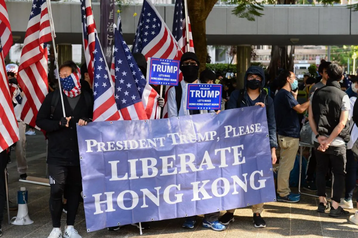 Protesters hold up a giant banner and U.S. flags at a rally at Charter Garden in Hong Kong on Dec. 1, 2019. (Sun Pi-lung/The Epoch Times)
