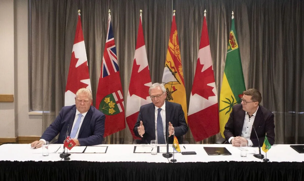 (L-R) Ontario Premier Doug Ford, New Brunswick Premier Blaine Higgs, and Saskatchewan Premier Scott Moe talk to the media in Toronto on Dec. 1, 2019. The premiers signed a "Collaboration Memorandum of Understanding" ahead of a meeting of Canada's provincial leaders on Dec. 2. (The Canadian Press/Chris Young)