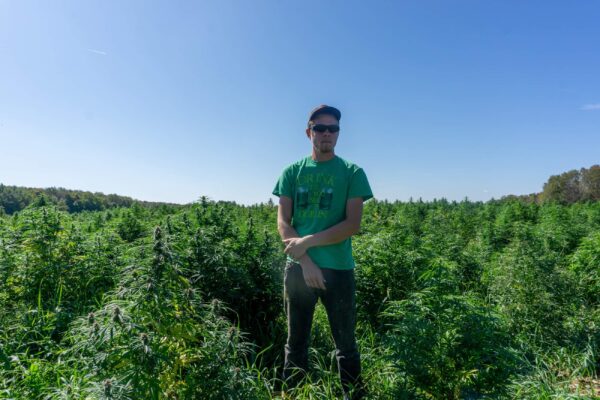 Dylan Barber standing in front of his 3-acre hemp field on Sept. 20, 2019. (Courtesy of Dylan Barber)