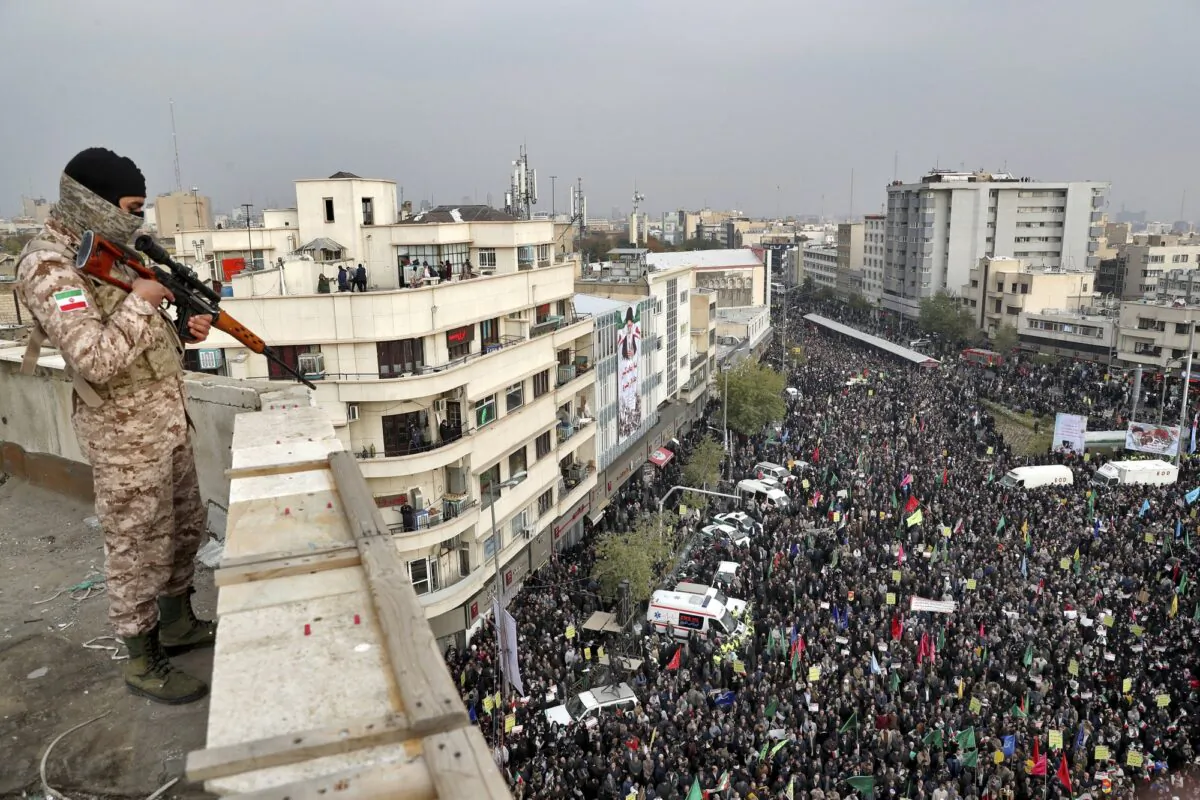 An Iranian soldier stands guard overlooking a pro-government rally organized by authorities in Tehran, Iran, on Nov. 25, 2019. (Ebrahim Noroozi/File/AP Photo)