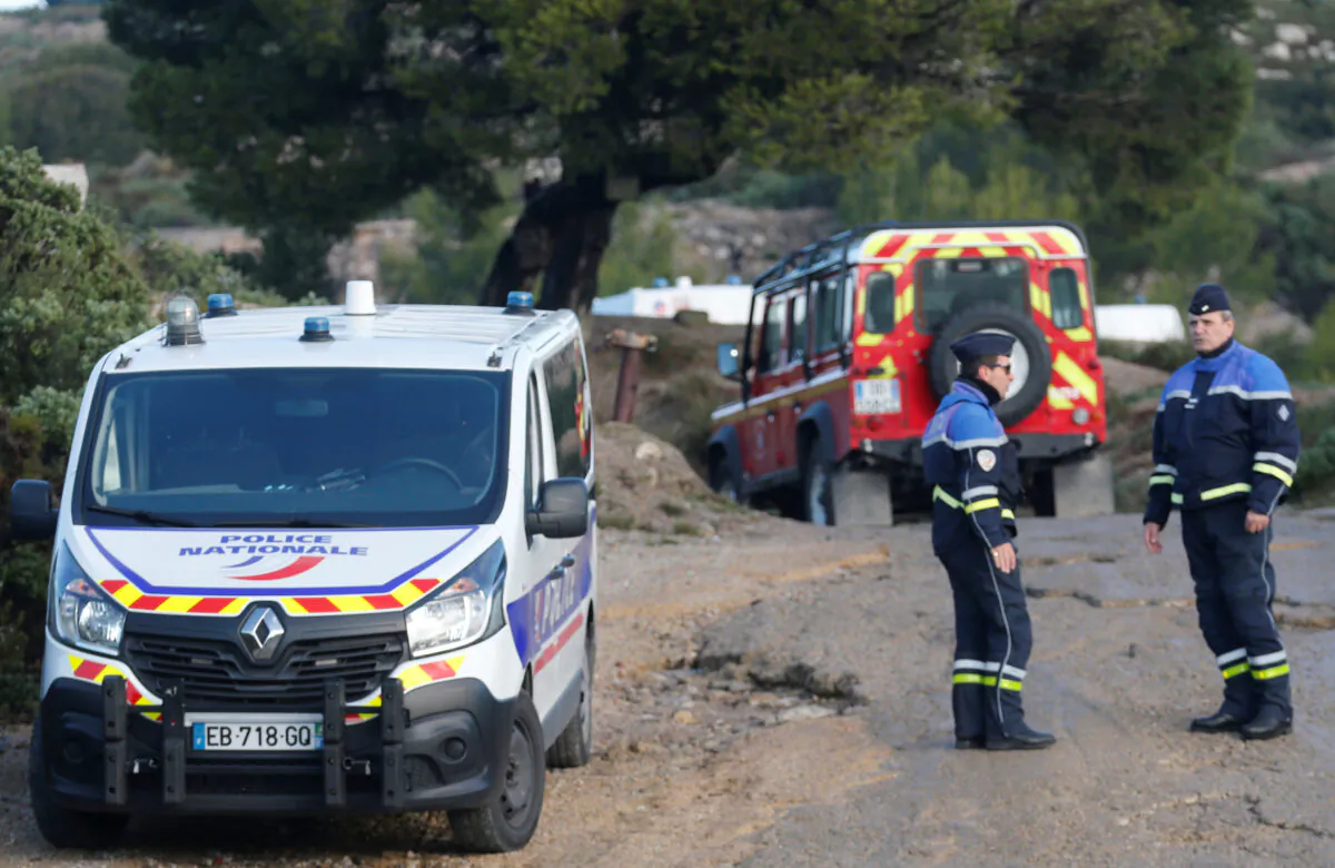 French police secure the area around the site where a helicopter from the civil security services crashed while en route to help people caught up in heavy flooding, in Le Rove near Les-Pennes-Mirabeau, France, Dec. 2, 2019. (Jean-Paul Pelissier/Reuters)