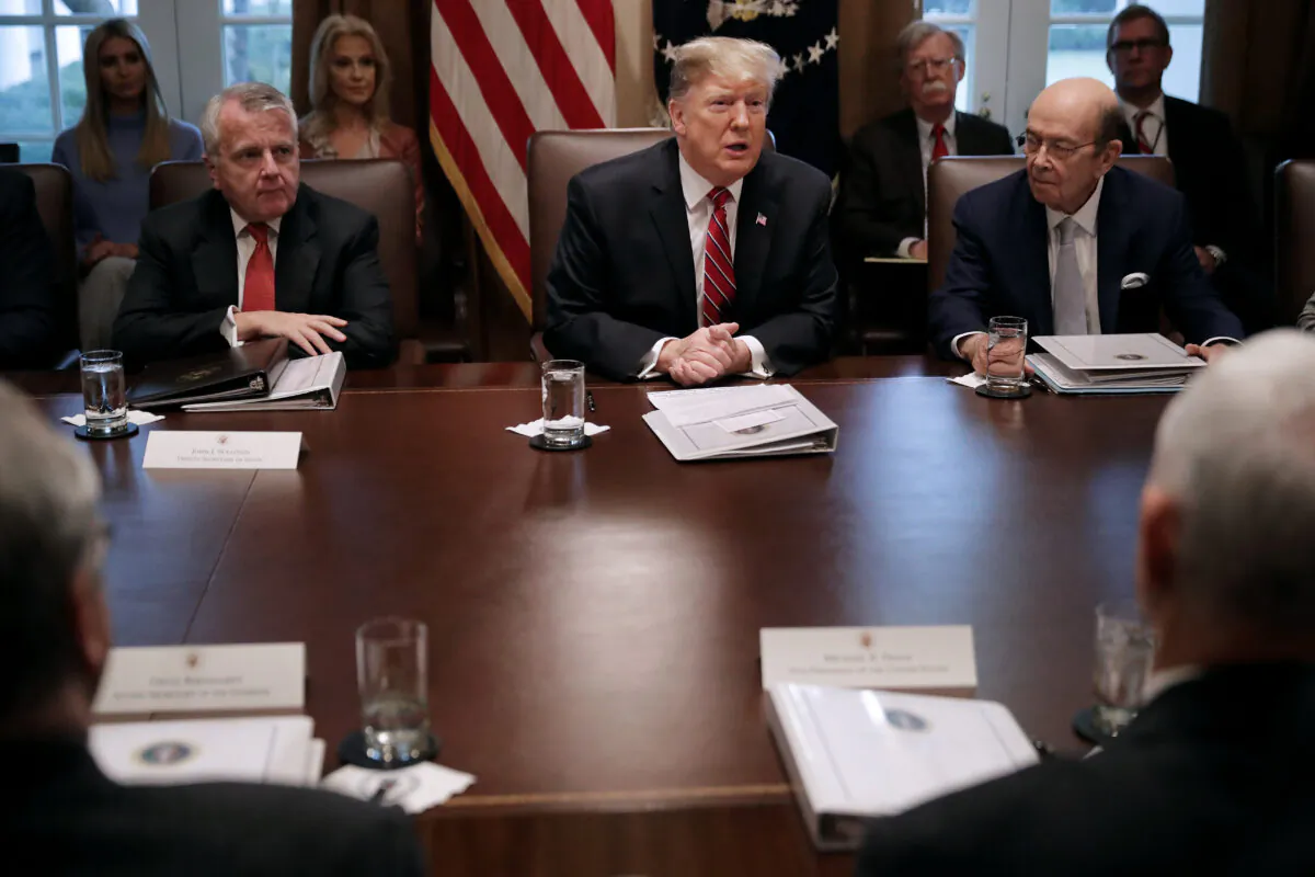 U.S. President Donald Trump (C) talks to reporters with Commerce Secretary Wilbur Ross (R) during a cabinet meeting at the White House in Washington, on Feb. 12, 2019. (Chip Somodevilla/Getty Images)