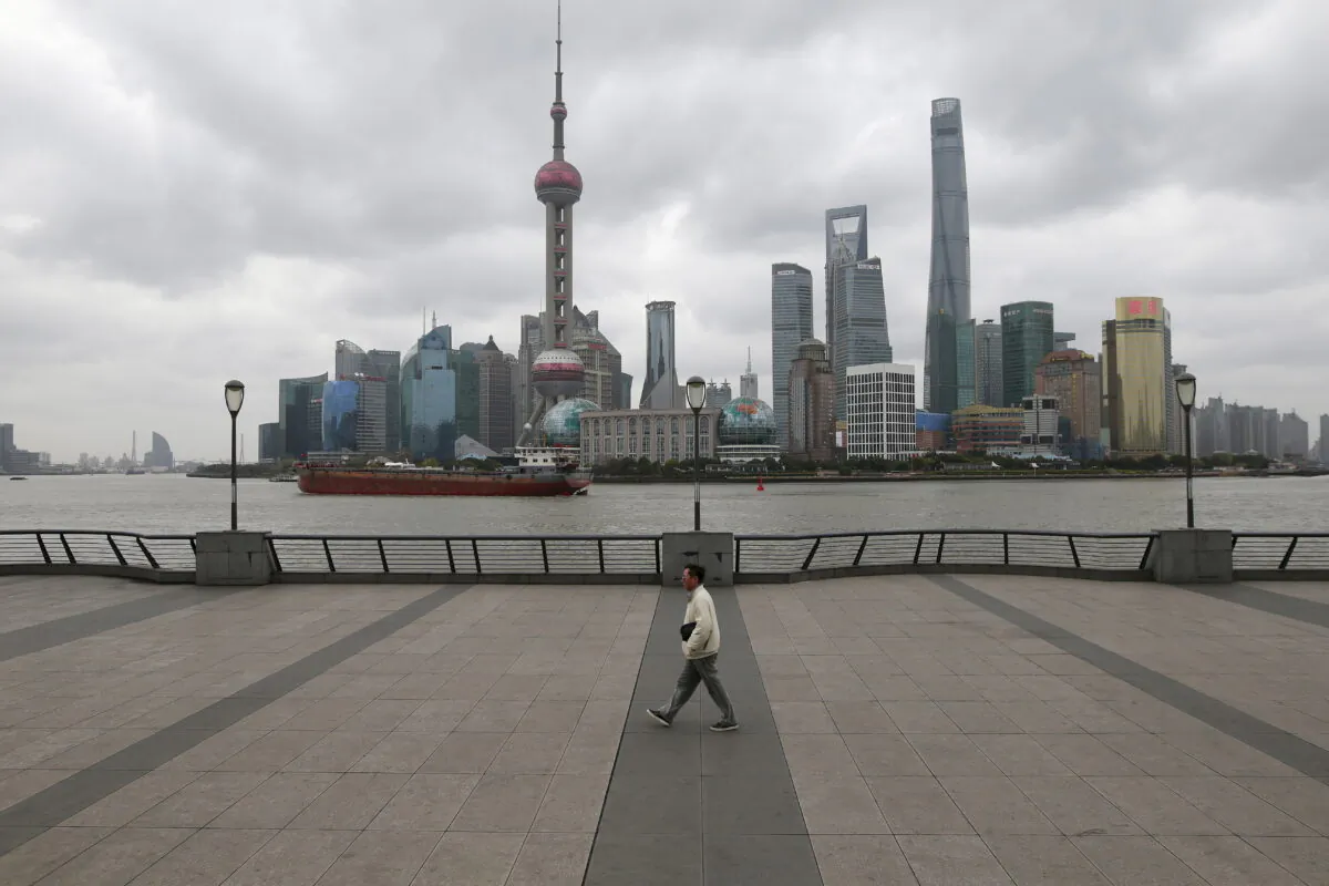 A man walks on the bund in front of the financial district of Pudong in Shanghai, China, on March 9, 2016. (Aly Song/Reuters)