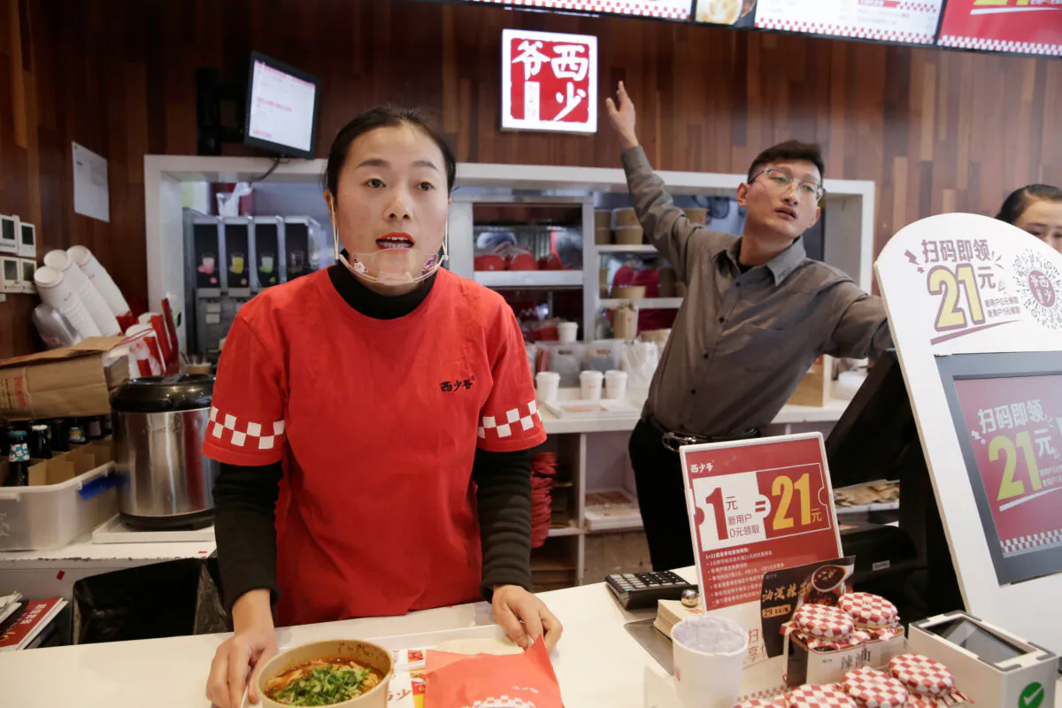 Employees work at a pork bun chain restaurant Xishaoye in Beijing, China on Nov. 22, 2019. (Jason Lee/Reuters)