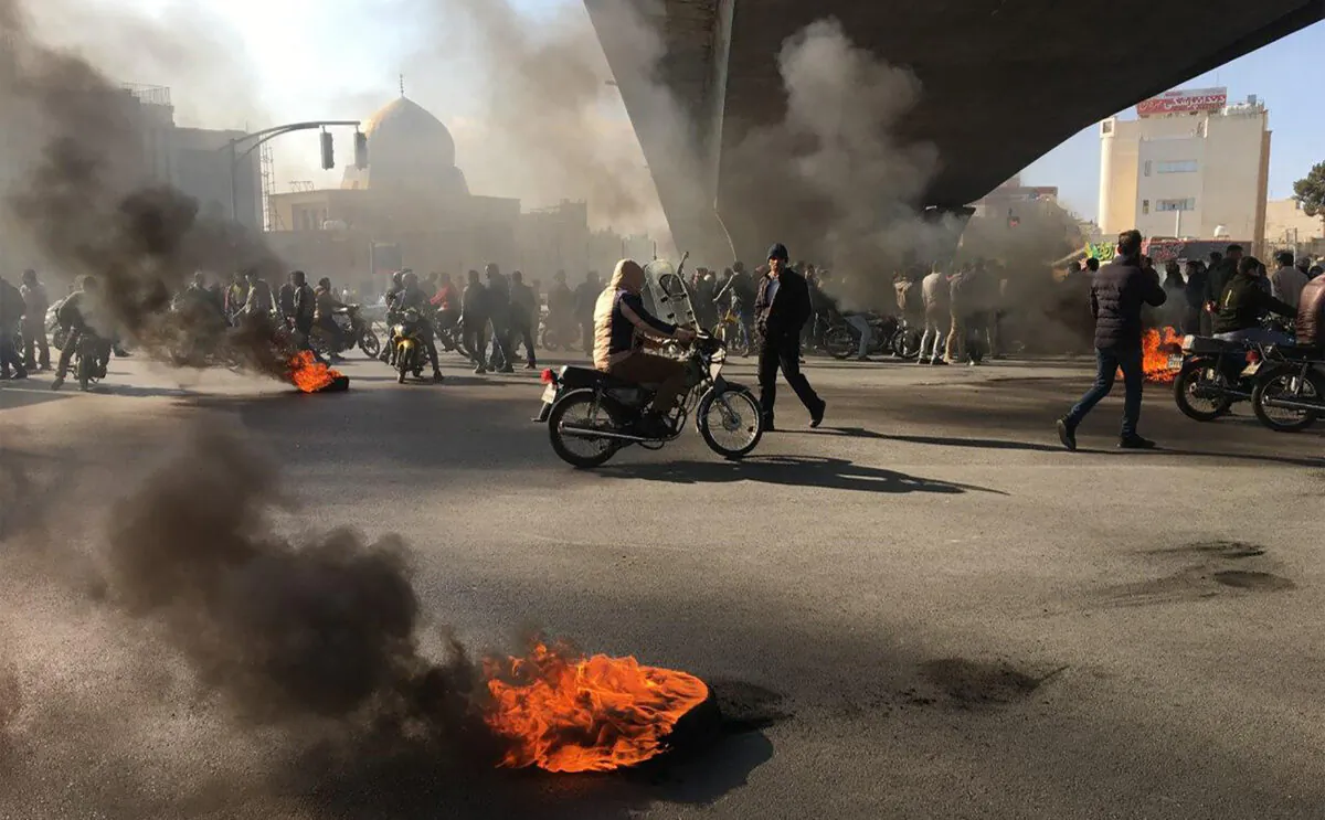Iranian protesters rally amid burning tires during a demonstration against an increase in gasoline prices, in the central city of Isfahan on November 16, 2019. (Photo by -/AFP via Getty Images)