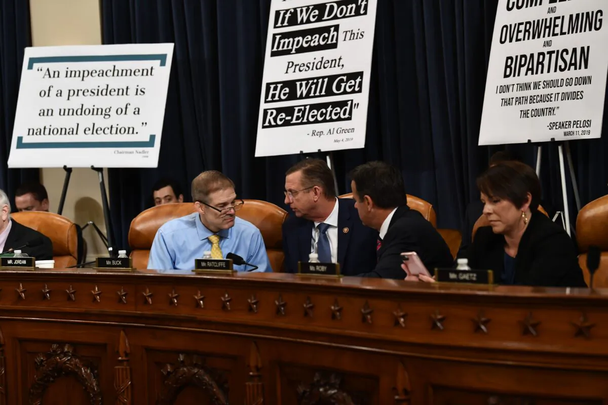 Ranking member Rep. Doug Collins (R-GA) speaks with Rep. Jim Jordan(L) R-OH as constitutional scholars testify before the House Judiciary Committee in the Longworth House Office Building on Capitol Hill December 4, 2019 in Washington, DC. (Photo by BRENDAN SMIALOWSKI/AFP via Getty Images)