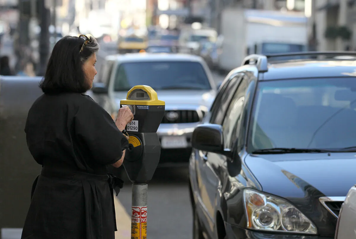 A woman puts money into a parking meter in San Francisco, Calif., on Jan. 21, 2011. (Justin Sullivan/Getty Images)