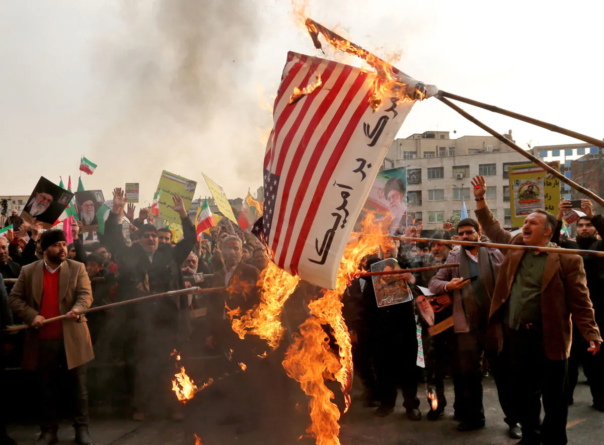 Iranian pro-government demonstrators burn a makeshift American flag in Tehran on Nov. 25, 2019. (Atta Kenare/AFP via Getty Images)