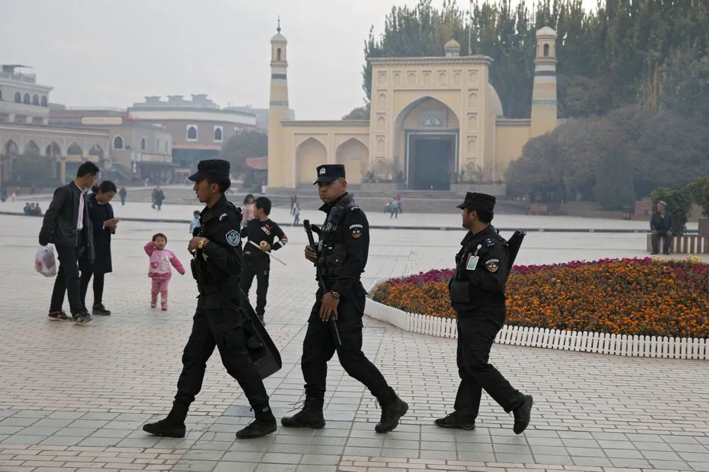 Uyghur security personnel patrol near the Id Kah Mosque in Kashgar in western China's Xinjiang region, on Dec. 4, 2019. (Ng Han Guan/AP Photo)
