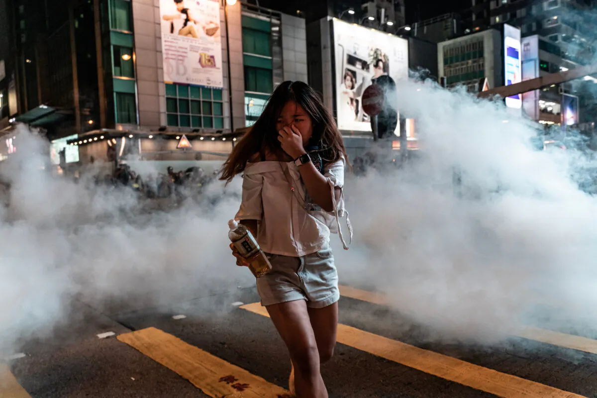 A pedestrian reacts after police fired tear gas in the Mongkok district in Hong Kong on October 27, 2019. (Anthony Kwan/Getty Images)