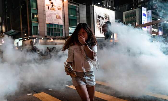 A pedestrian reacts after police fired tear gas in the Mongkok district in Hong Kong on October 27, 2019. (Anthony Kwan/Getty Images)