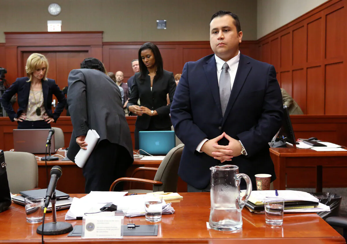 George Zimmerman (R) stands at the start of the fourth day of his murder trial in Seminole circuit court in Sanford, Fla., on June 13, 2013. (Joe Burbank-Pool/Getty Images)
