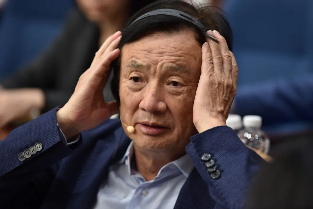 Huawei founder and CEO Ren Zhengfei adjusts his headphones as he hosts a panel discussion in Shenzhen, China, on June 17, 2019. (Hector Retamal/AFP via Getty Images)