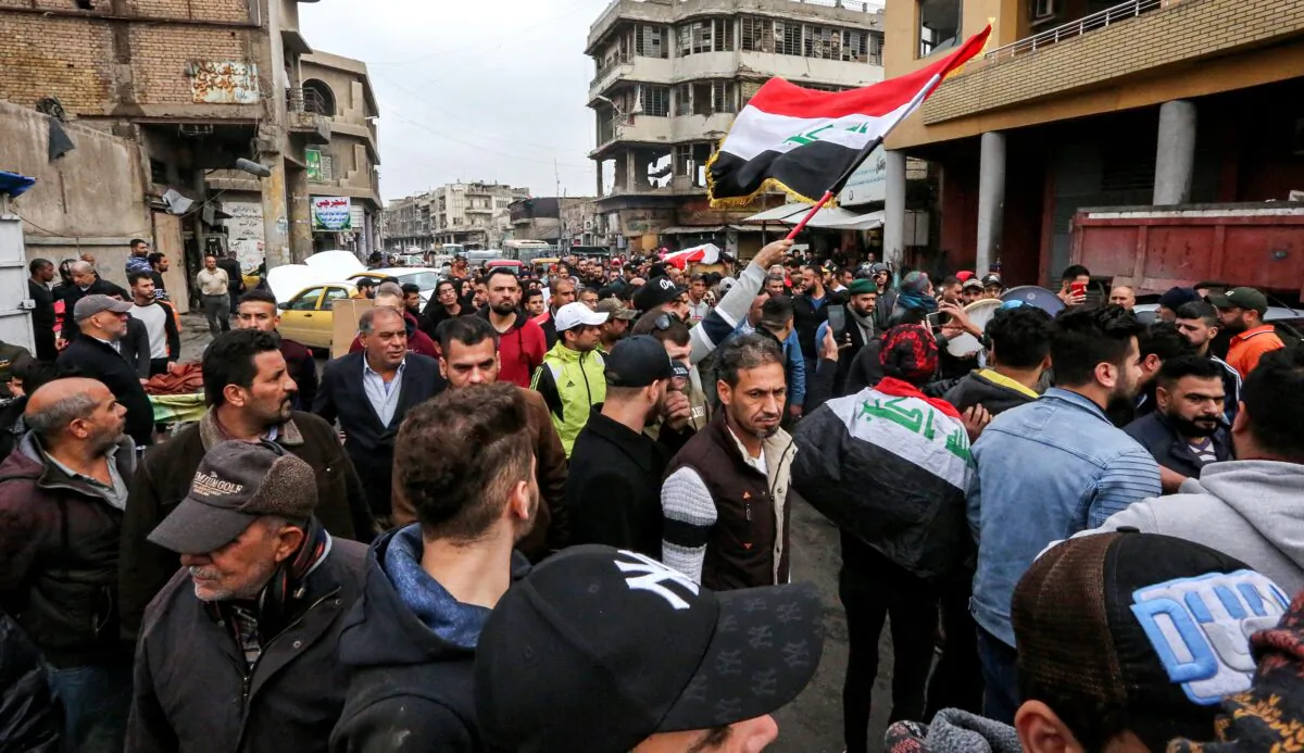 Iraqi mourners gather for the funeral of an anti-government protester who died from injuries sustained in previous confrontations with security forces, in the capital Baghdad on Dec. 3, 2019. (Sabah Arar/AFP via Getty Images)