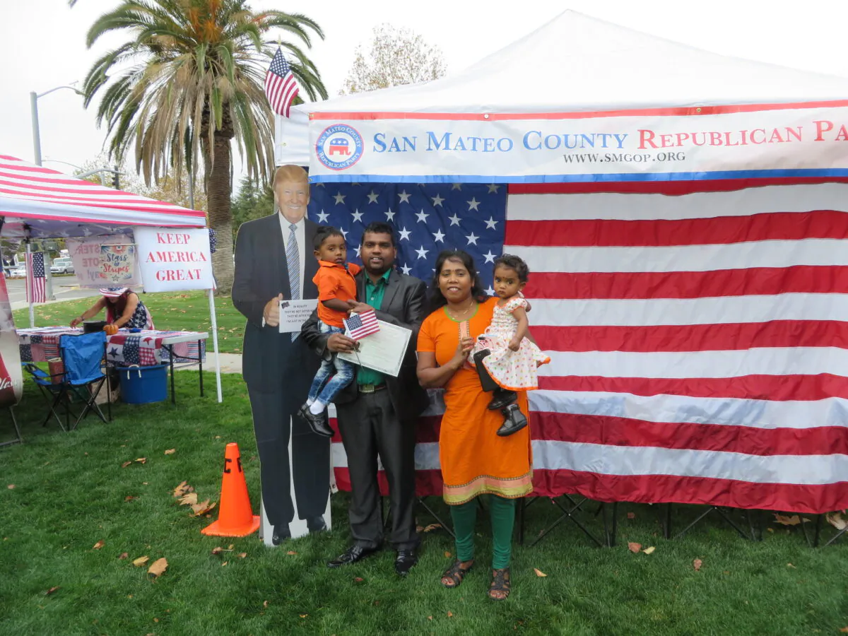 Matheeswaran Tharmarathinan and his family took a picture with Trump cutout on Nov. 26 at Naturalization Ceremony in Santa Clara County. (Nathan Su/The Epoch Times)