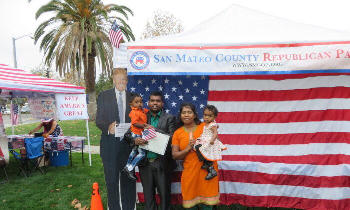 Matheeswaran Tharmarathinan and his family took a picture with Trump cutout on Nov. 26 at Naturalization Ceremony in Santa Clara County. (Nathan Su/The Epoch Times)