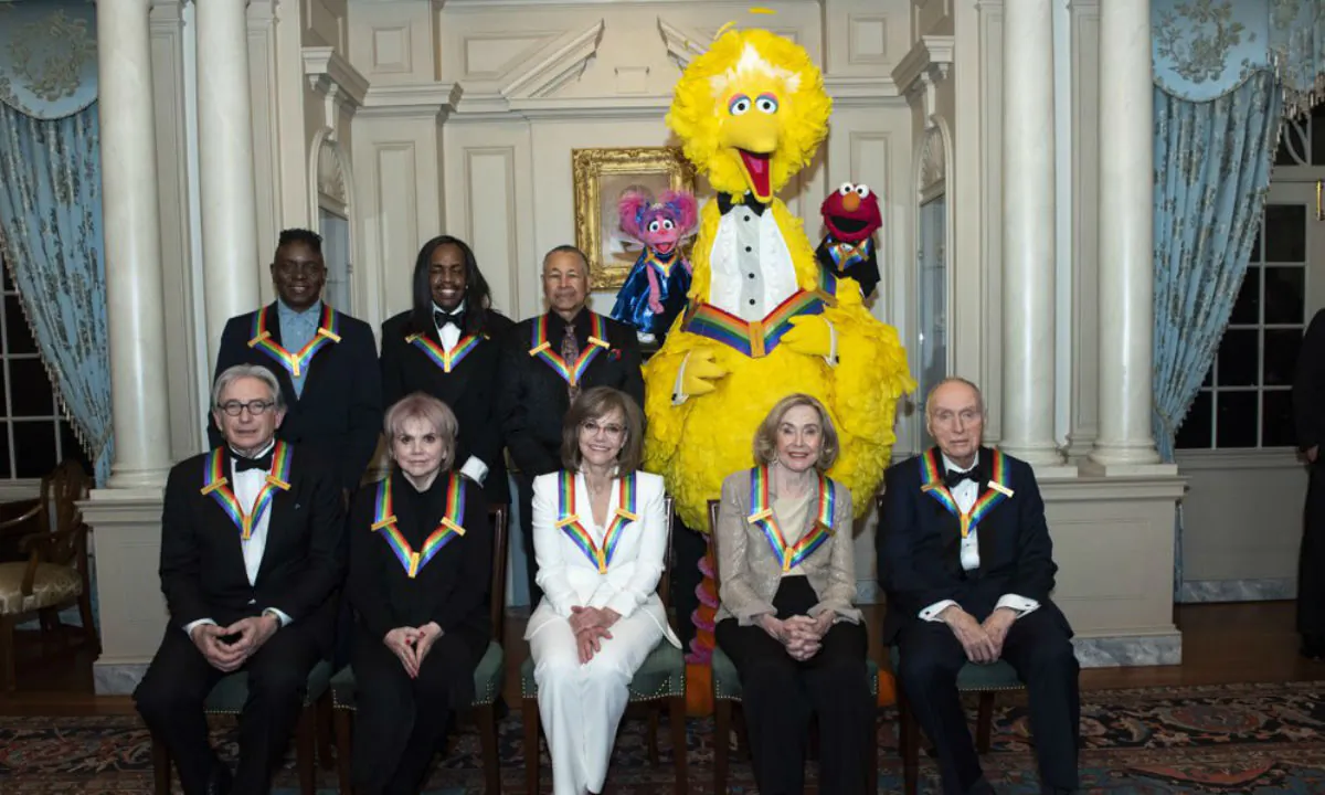 Front row from left, 2019 Kennedy Center Honorees Michael Tilson Thomas, Linda Ronstadt, Sally Field, Joan Ganz Cooney, and Lloyd Morrisett. Back row from left, Philip Bailey, Verdine White, Ralph Johnson, and characters from "Sesame Street," Abby Cadabby, Big Bird, and Elmo in Washington, on Dec. 7, 2019. (Kevin Wolf/AP Photo) 