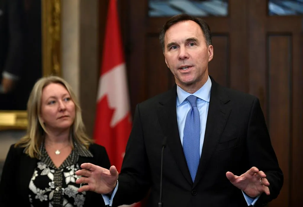 Minister of Finance Bill Morneau and Minister of Middle Class Prosperity and Associate Minister of Finance Mona Fortier make an announcement on lowering taxes for the middle class in Ottawa, on Dec. 9, 2019. (The Canadian Press/Justin Tang)