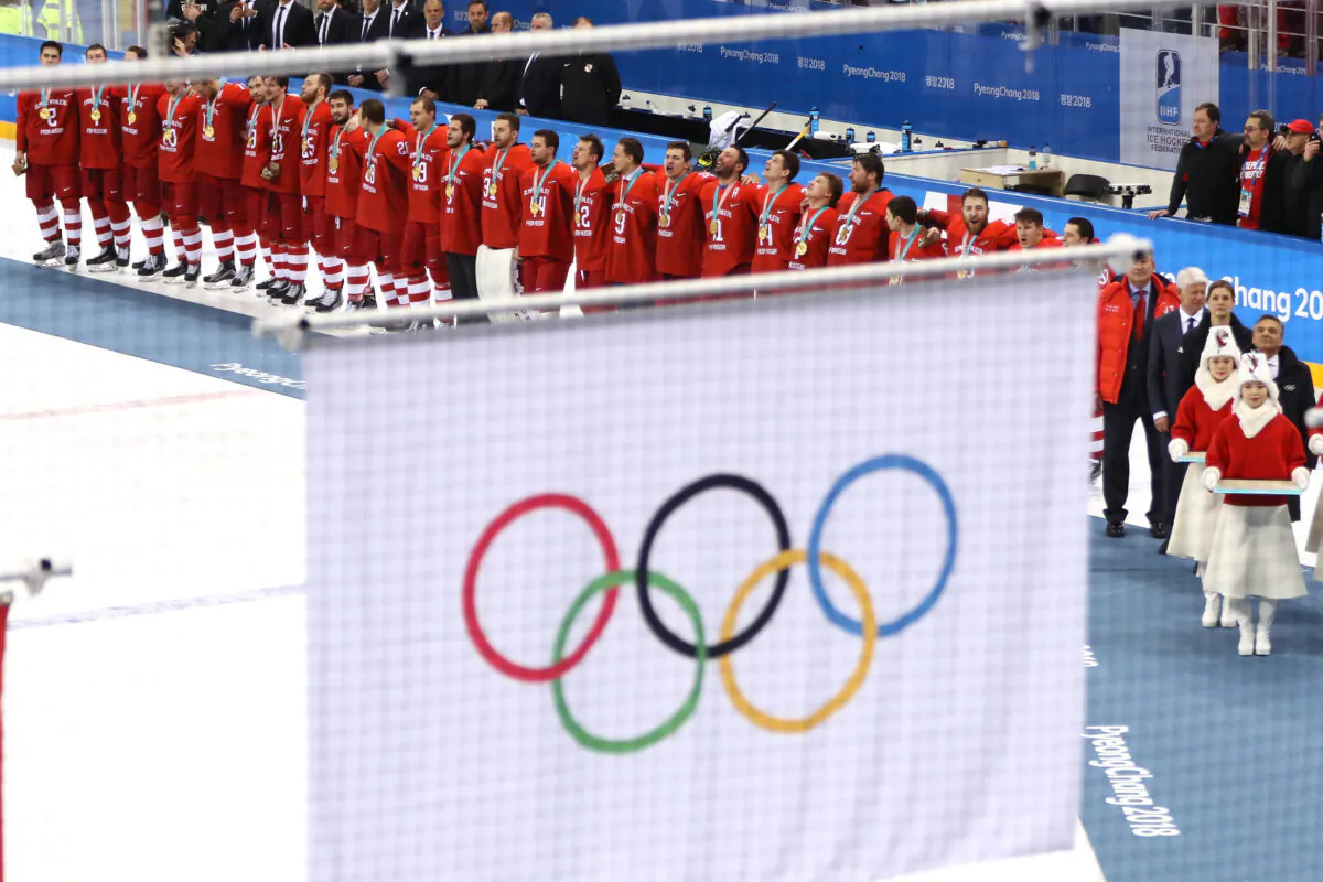 Gold medal winners Olympic Athletes from Russia look on as the Olympic flag is raised during the medal ceremony after the Men's Gold Medal Game against Germany on day sixteen of the PyeongChang 2018 Winter Olympic Games at Gangneung Hockey Centre in Gangneung, South Korea on Feb. 25, 2018. (Jamie Squire/Getty Images)