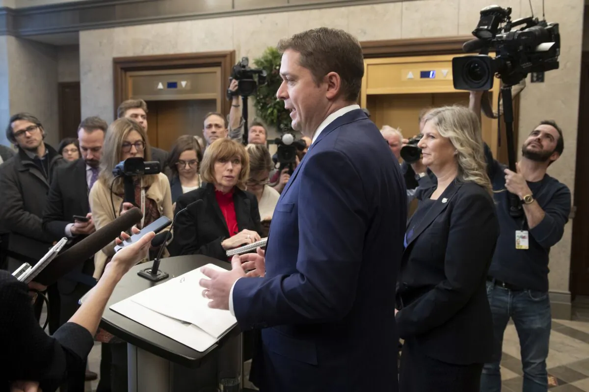 Conservative Party Leader Andrew Scheer speaks with the media in the foyer of the House of Commons as Deputy Leader Leona Alleslev looks on, on Nov. 28, 2019. (The Canadian Press/Adrian Wyld)