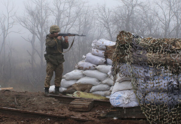 A Ukrainian soldier takes position on the front line at the town of Novoluhanske in the Donetsk region, Ukraine, Monday, Dec. 9, 2019. (Vitali Komar/ AP Photo)