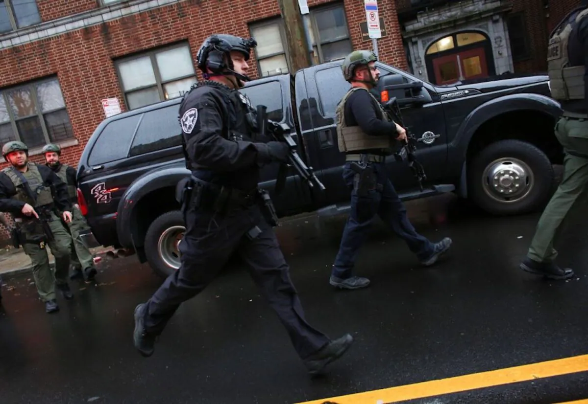 Police officers arrive to the scene where active shooting is happening in Jersey City. One officer was shot when two gunmen with a long rifle opened fire. Two suspects were barricaded in a convenience store, according to officials on Dec. 10, 2019. (Photo by Kena Betancur/AFP via Getty Images)