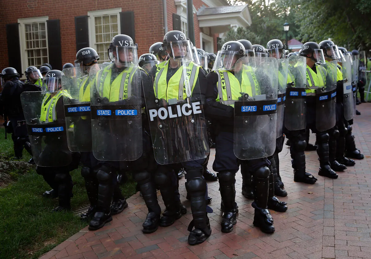 Members of the Virginia State Police stand guard in riot gear on the campus of the University of Virginia during an event in Charlottesville, Virginia on Aug. 11, 2018. (Win McNamee/Getty Images)
