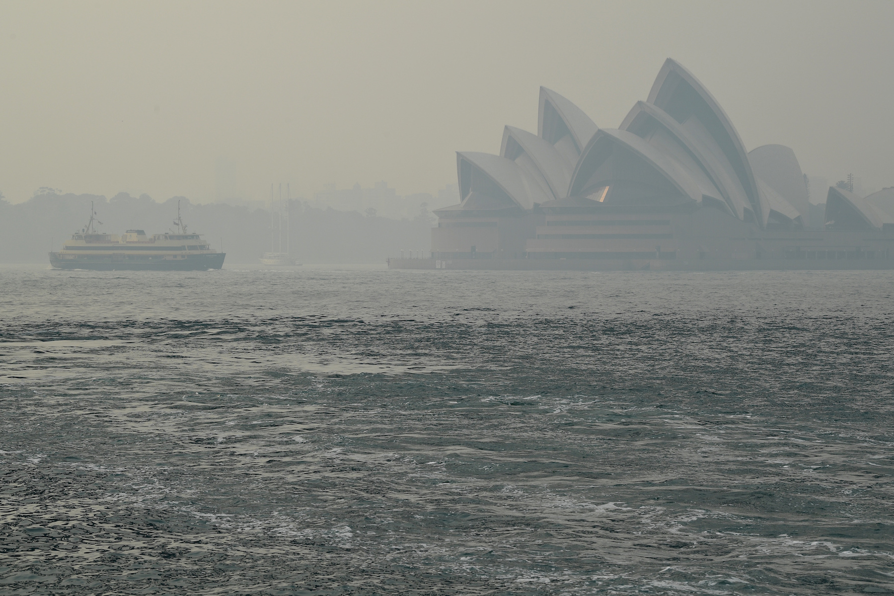 Sydney Opera House can be seen as smoke haze from bushfires in New South Wales blankets the CBD in Sydney