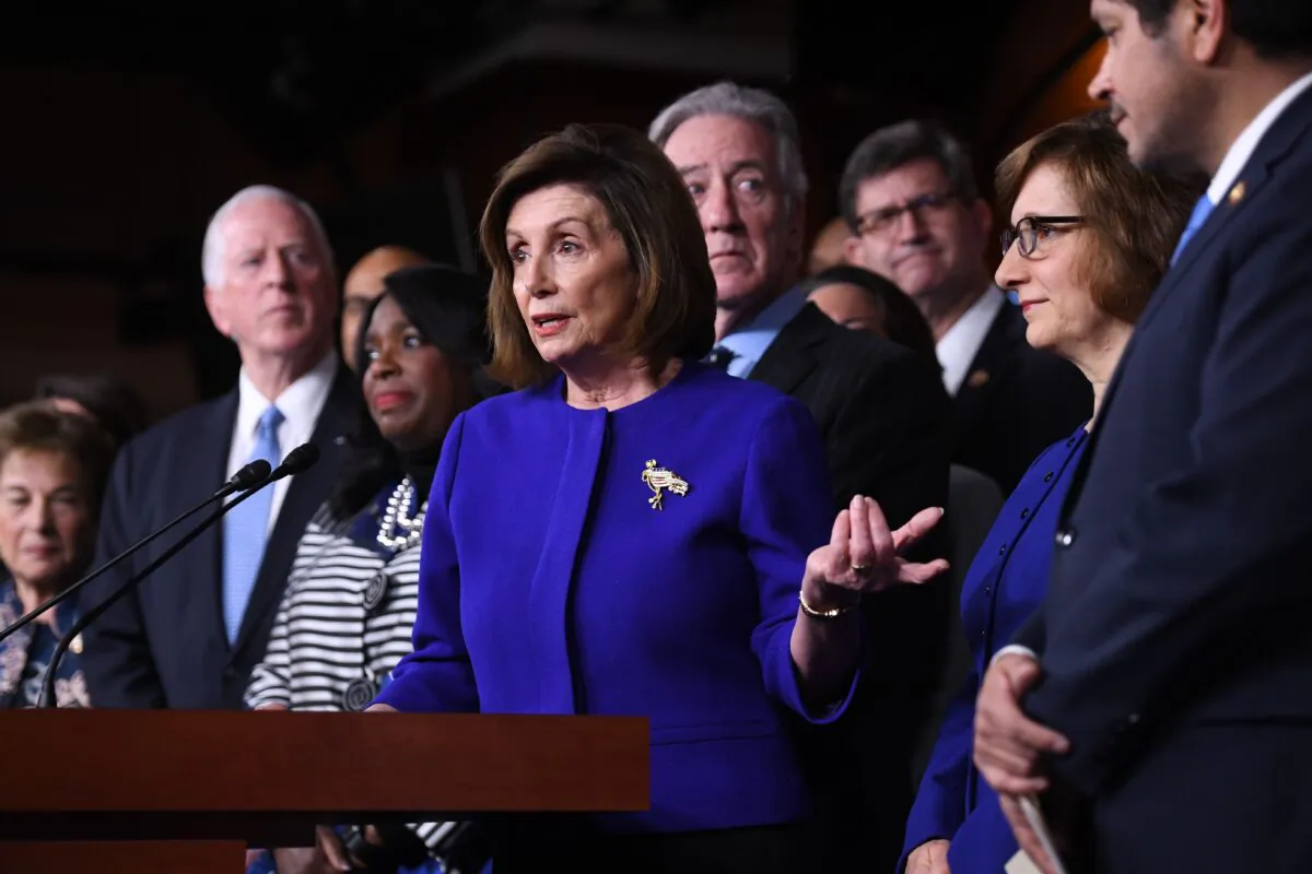House Speaker Nancy Pelosi (D-Calif.) and House Ways and Means Committee Chairman Richard Neal, behind her, speak about the US - Mexico - Canada Agreement, known as the USMCA, on Capitol Hill in Washington, on Dec. 10, 2019. (Saul Loeb/AFP via Getty Images)