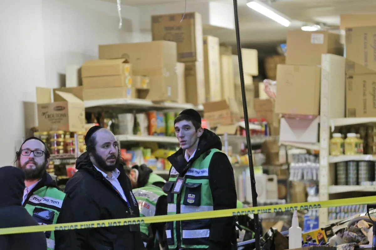 Emergency responders work at a kosher supermarket, the site of a shooting in Jersey City, N.J., on Dec. 11, 2019. Jersey City Mayor Steven Fulop said authorities believe gunmen targeted the market during a shooting that killed multiple people Tuesday. (Seth Wenig/AP Photo)