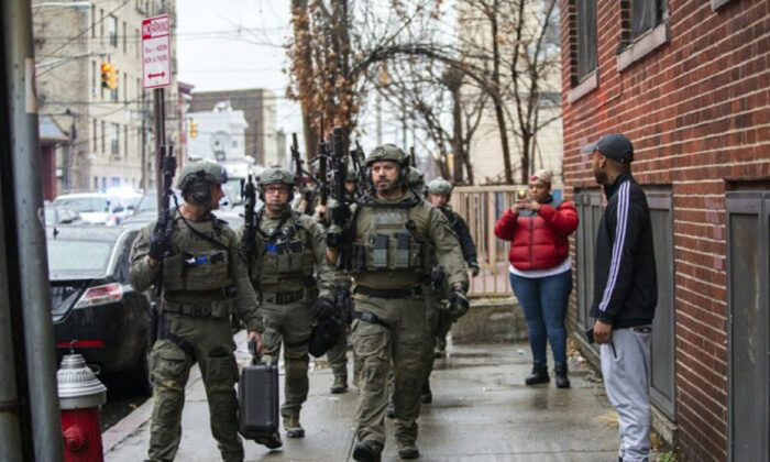 Police officers arrive at the scene following reports of gunfire, in Jersey City, N.J., on Dec. 10, 2019. (Eduardo Munoz Alvarez/AP Photo)