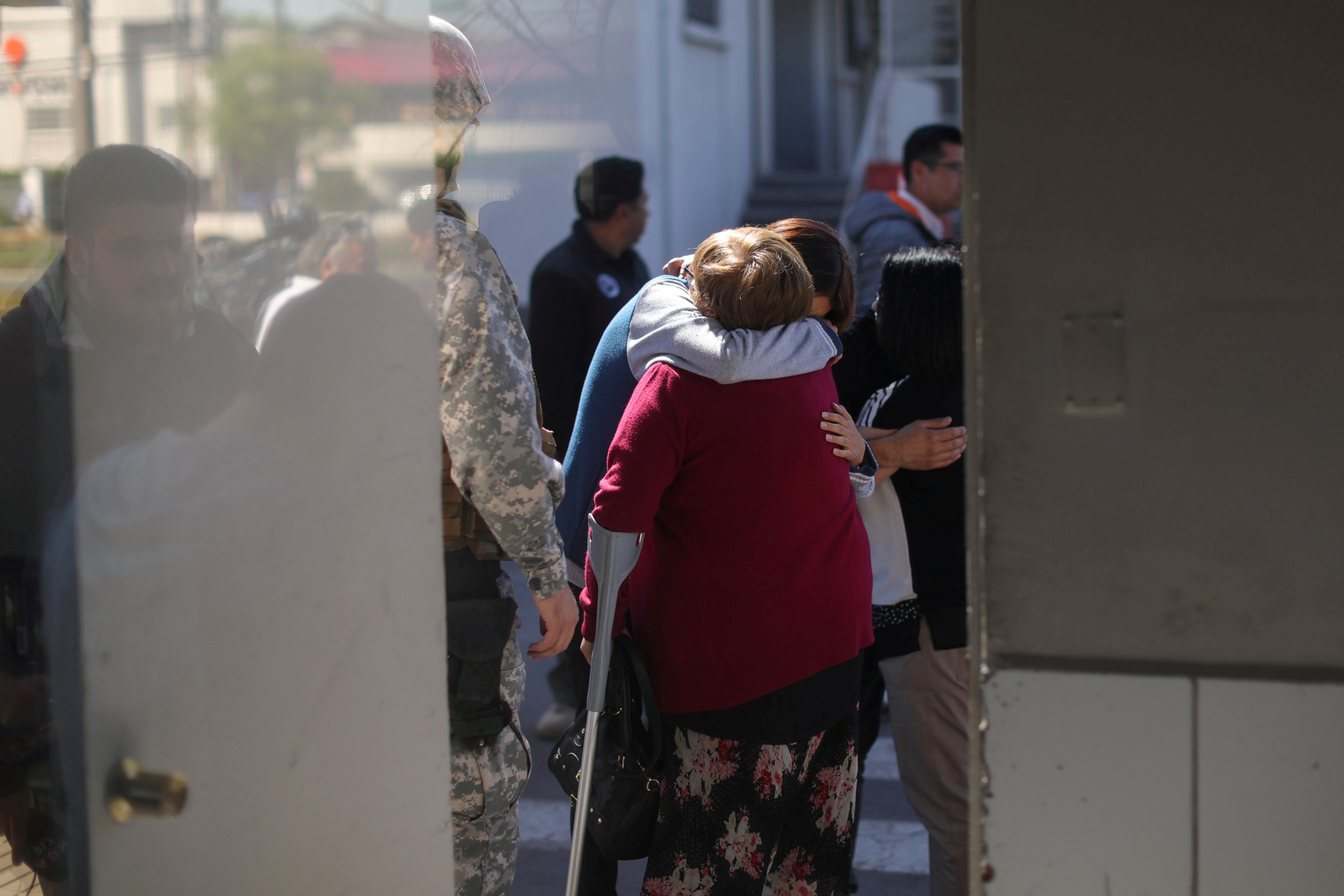 FILE PHOTO: People react inside an air force base in Santiago