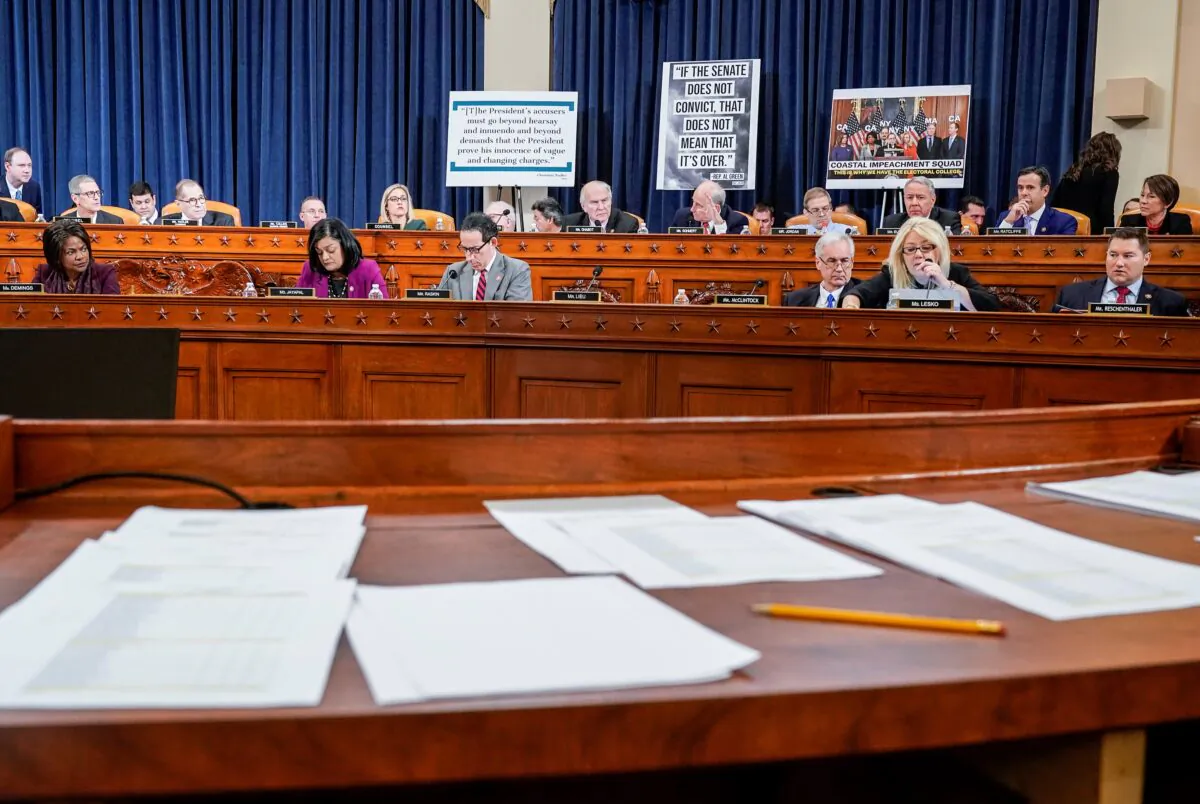 Documents including copies of House Resolution 755 "Articles of Impeachment Against President Donald J. Trump," are seen as the House Judiciary Committee continues its markup of articles of impeachment against President Donald Trump on Capitol Hill in Washington on Dec. 12, 2019. (Joshua Roberts/Reuters)