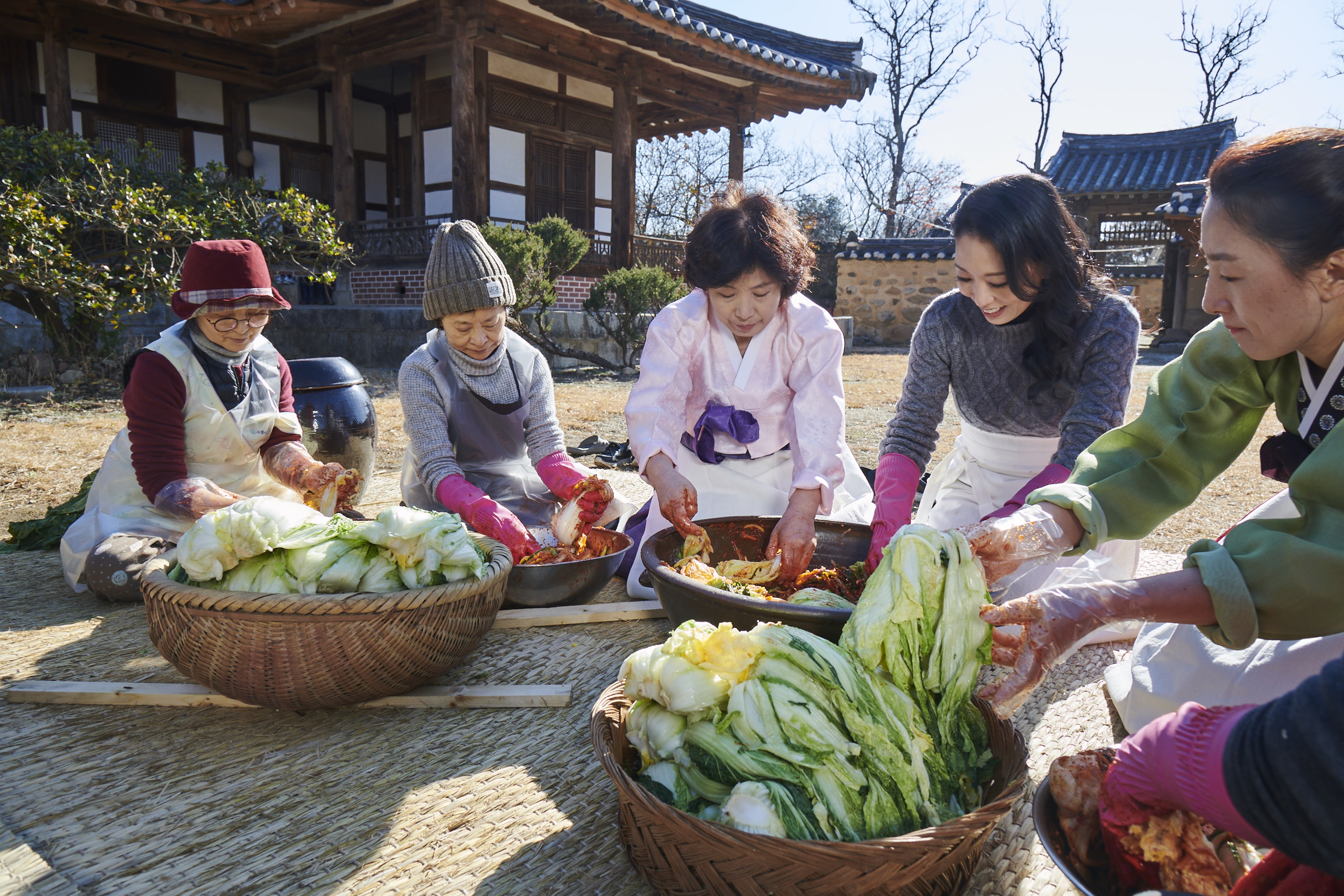 group of korean women making kimchi