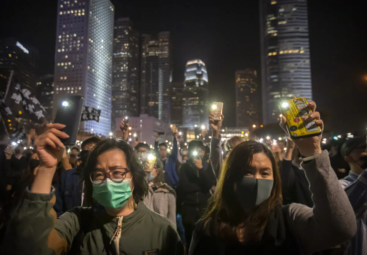 Protestors hold up their smartphone lights at a rally in Hong Kong, China on Dec. 12, 2019. (Mark Schiefelbein/AP Photo)