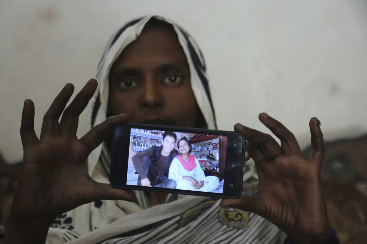 Pakistani Christian woman Samiya David shows her picture with Chinese husband, in Gujranwala, Pakistan. Samiya had been in China just two months when her brother got a phone call telling him to pick her up at the airport. When he arrived, he found Samiya in a wheelchair, malnourished and too weak to walk, said her cousin Pervaiz Masih. She died barely five weeks later. Masih was among the relatives who prepared Samiya's grave and attended her burial in May. (K.M. Chaudary/AP Photo)
