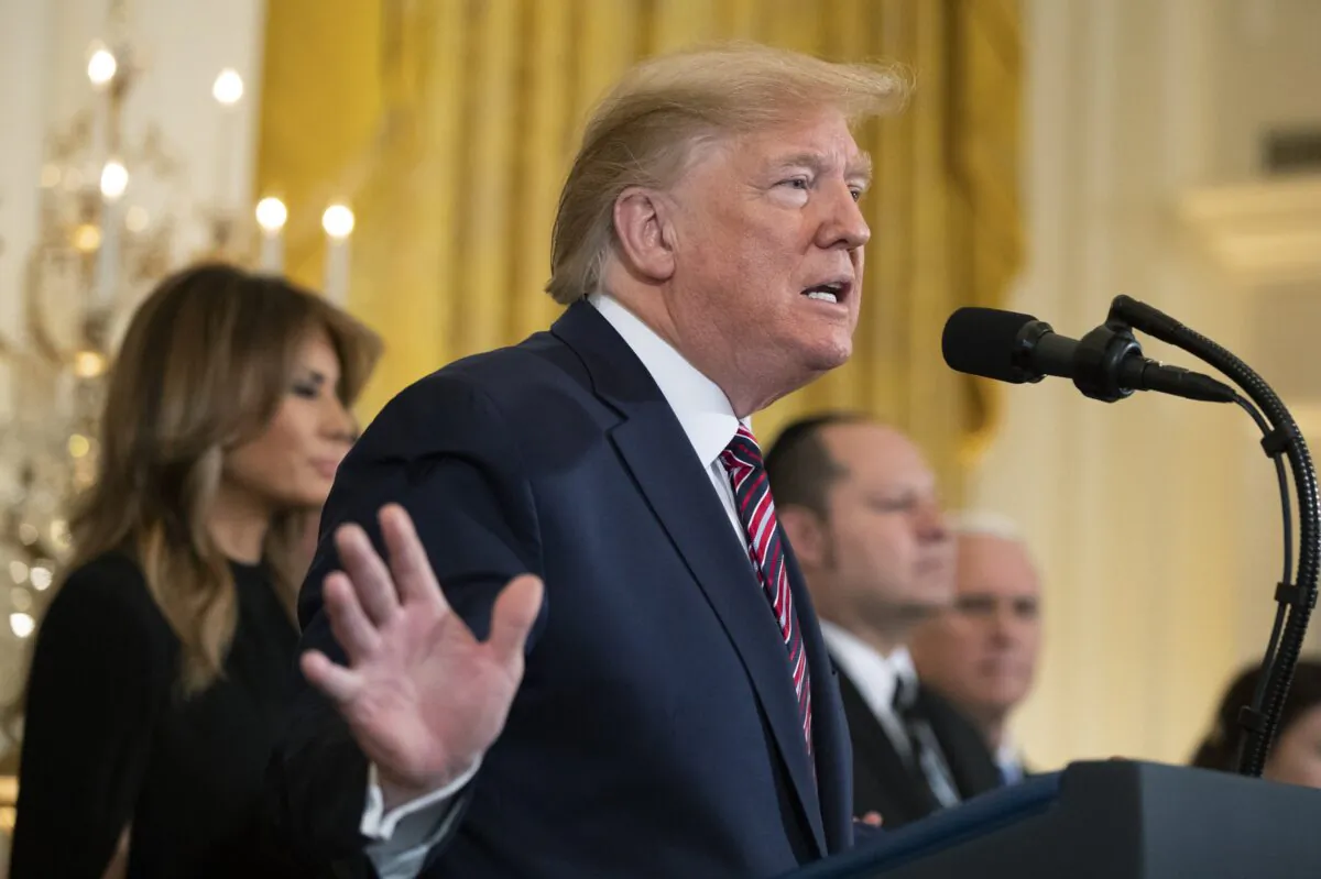 President Donald Trump with First Lady Melania Trump, speaking during a Hanukkah reception in the East Room of the White House in Washington on Dec. 11, 2019. (Manuel Balce Ceneta/AP Photo)
