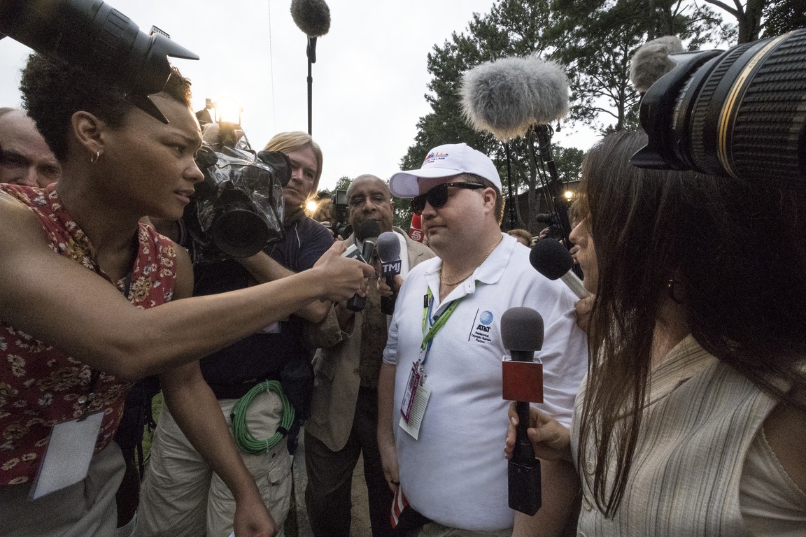 man surrounded by media