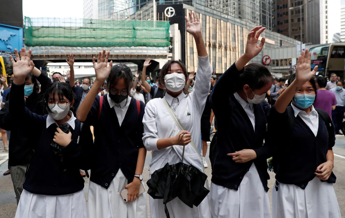 Demonstrators wear face masks during a pro-democracy protest in Central, Hong Kong, China on Nov. 12, 2019. (Shannon Stapleton/Reuters)