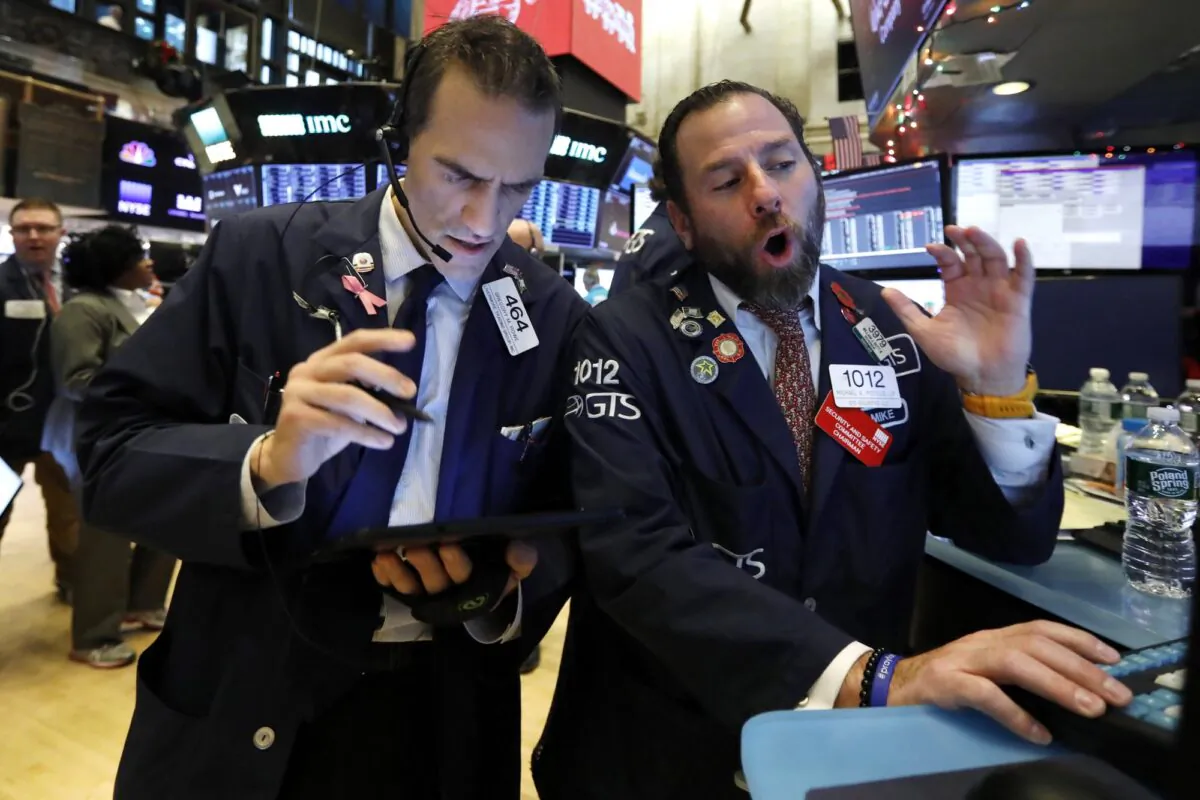 Trader Gregory Rowe (L) and specialist Michael Pistillo work on the floor of the New York Stock Exchange on Dec. 5, 2019. (Richard Drew/AP Photo)