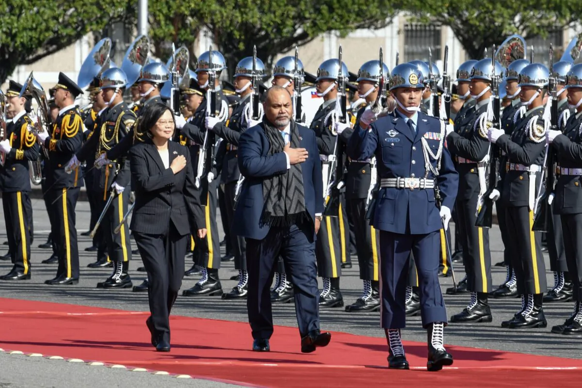 Nauru's President Lionel Aingimea (C) and Taiwan's President Tsai Ing-wen (L) inspect an honor guard during a welcome ceremony outside the Presidential Palace in Taipei on Dec. 13, 2019. (Sam Yeh/AFP via Getty Images)