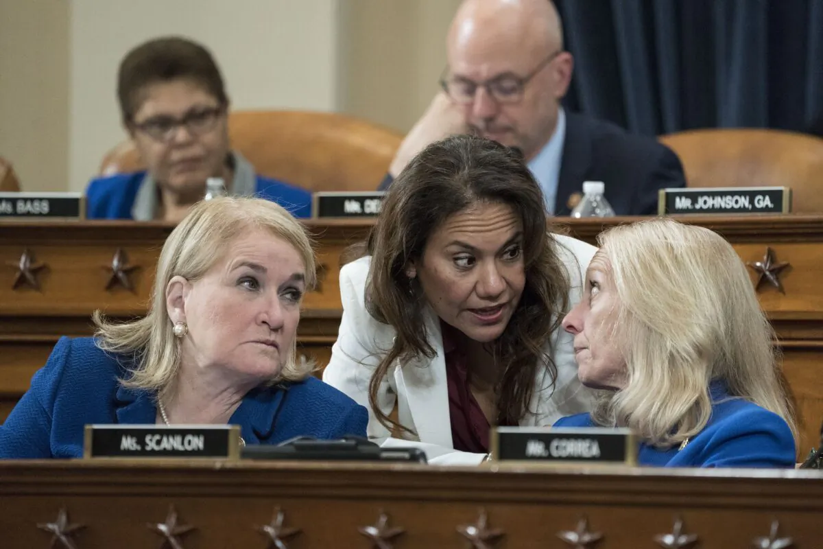 Rep. Veronica Escobar (D-Texas), center, talks with Reps. Sylvia Garcia (D-Texas) and Mary Gay Scanlon (D-Penn.) during a House Judiciary Committee markup hearing on the articles of impeachment against President Donald Trump in the Longworth House Office Building on Capitol Hill in Washington on Dec. 12, 2019. (Sarah Silbiger/Getty Images)