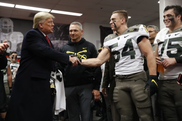 President Donald Trump shakes hands with Army player Cole Christiansen