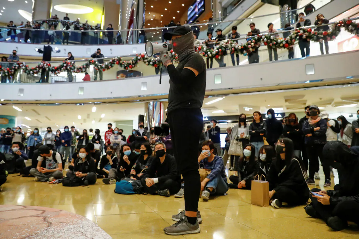 A protester delivers a speech during a demonstration inside a shopping mall in Taikoo, in Hong Kong, China Dec. 15, 2019. (Reuters/Thomas Peter)