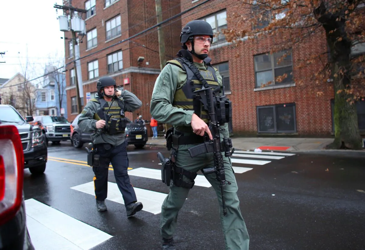 Police officers arrive on the scene during a shooting at JC Kosher Supermarket in Jersey City on Dec. 10, 2019, that left five dead, including the two armed suspects. The suspects had earlier shot a police officer. (Kena Betancur/AFP via Getty Images)